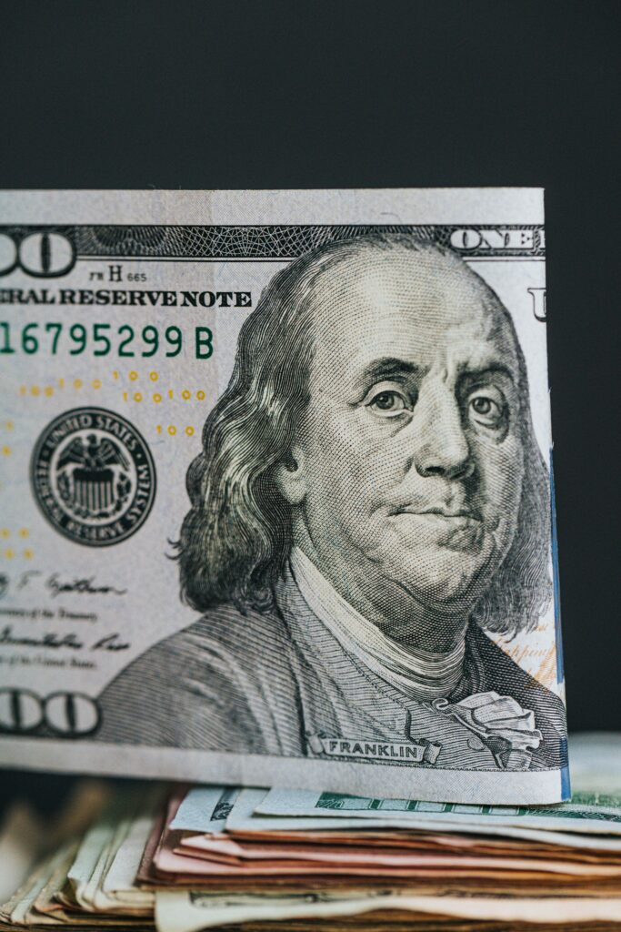 Close-up of a $100 bill on top of other bills